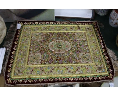 An Islamic scroll, a Chinese brocade panel, an embroidered and mounted panel and a book