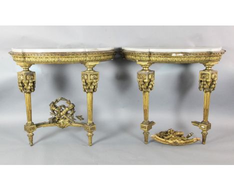 A pair of Louis XVI style giltwood pier tables, the semi-circular white marble tops with ribbon carved edges over leaf carved