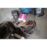 Oil filled arc welder on trolley with 3x masks, 3x gas argon canisters & a quantity of welding rods.