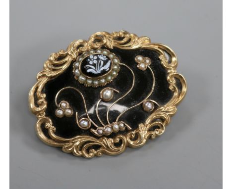 A Victorian gold plated, black enamel, split pearl and hardstone set mourning brooch, with foliate decoration, 56mm.
