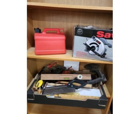 A collection of various vintage tools, and a power saw. 