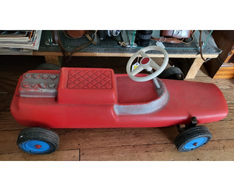 A red plastic racing car floor toy with steering. 73cm, a Triang trailer with a trolley. (3) 