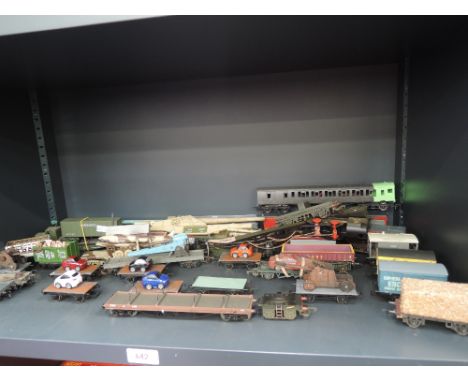 A shelf of 00 gauge rolling stock including Triang, Peco etc