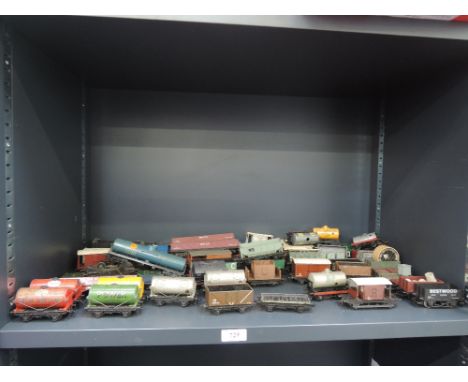 A shelf of Hornby Dublo and similar 00 gauge rolling stock including petrol tankers, brick wagons etc