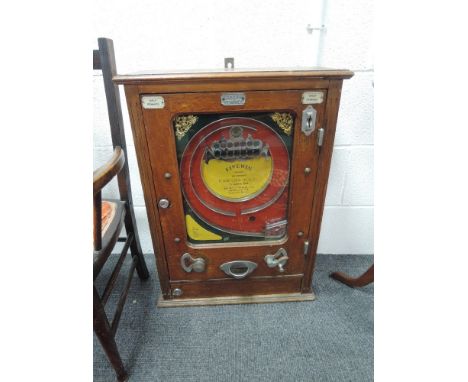 A 1930's 'FiveWin' place coin in the slot amusement arcade machine with half pennies and keys