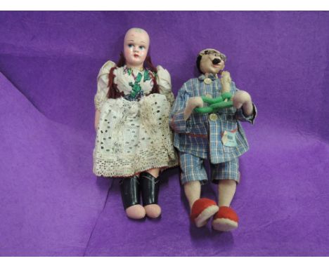 A vintage composition headed doll having cloth body and a souvenir doll having cloth body 