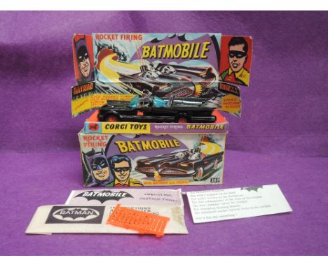 A Corgi die-cast, Batmobile on card display stand, with operating instruction papers, stick on labels, twelve rockets, on car