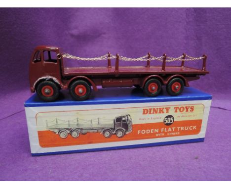 A Dinky Toys diecast, Foden flat truck with chains in maroon and in non original box  505 with replacement chains and repaint