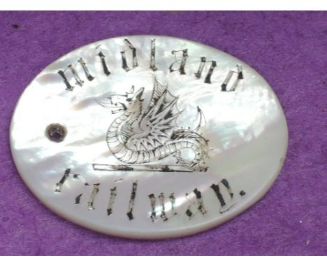An oval mother of pearl Midland Railway Free Ticket token bearing name and having hole for suspension