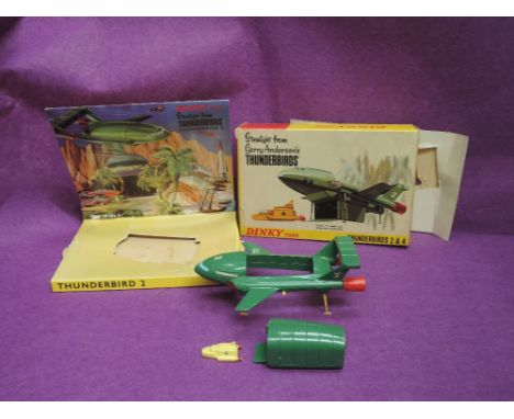 A Dinky die-cast, Thunderbird 2 push button undercarriage release, detachable pod with opening ramp door, containing Thunderb