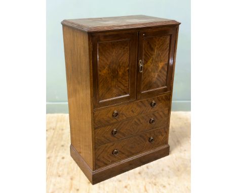 An Edwardian quarter panel flame mahogany veneered tallboy/drinks cabinet fitted twin panel doors, with single shelved interi
