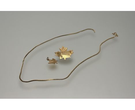 A 14ct gold Canadian maple leaf brooch: l. x 3cm and charm 3.9g and a 9ct gold fine box link chain necklace broken 3.26g (3)