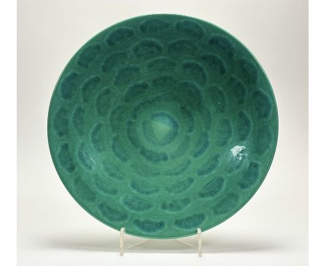 A Poole Pottery celadon/green "living glazed" charger, marked verso. (w-41cm)