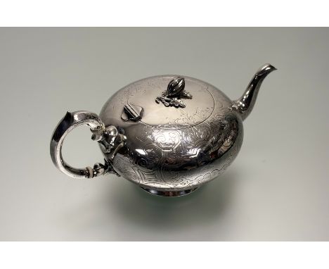 A Victorian London silver tea pot of circular squat form with pumpkin knop and C scroll handle with ivory resistors with engr