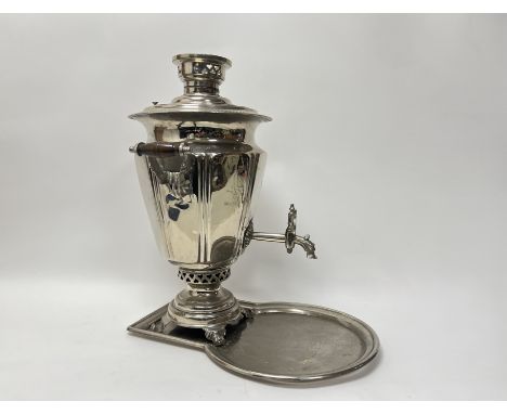 A 20thc Russian silver plated Samovar with twin handles, four scroll feet and complete with pierced heart top and base (h. 51