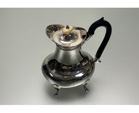 A Sheffield silver coffee pot of baluster form with ivory knop and ebony handle raised on pad feet: h. x 20cm Sheffield 1934 