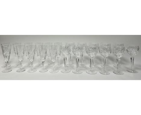 A collection of Waterford crystal glasses comprising, a set of eleven champagne flutes, and eleven cut crystal wine glasses w