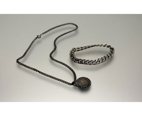 A white metal curb link fixed bracelet: d. x 9cm and silver a Gimpaoli cancer mounted pendan: d. x 2.5cm on silver curb link 