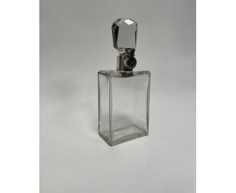 A silver mounted decanter by Hukin &amp; Heath Ltd, Birmingham, 1924, a plain oblong glass body with a large faceted stopper 