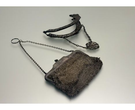 A plated Edwardian evening bag mount with floral and scroll design: d. x 14cm and an Edwardian plated evening purse with a pi