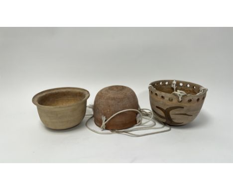 A collection of three planters comprising, a hanging terracotta planter with four punched holes to perimeter and hanging rope