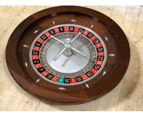 A Casino mahogany roulette wheel with working wheel on cast base: h. x 17.5cm d. x 79cm 