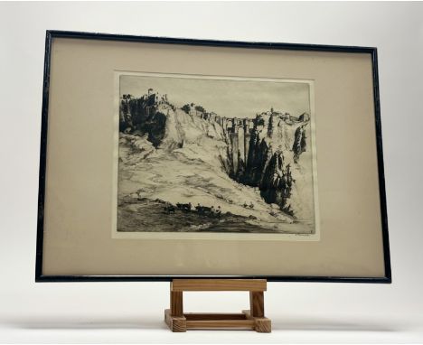 Sidney Tushingham (British 1884-1968), Rural Clifftop Town with men and donkeys, etching, signed pencil, framed (plate 26.5cm