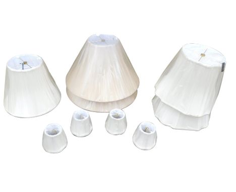 Two pairs of cream beige lamp shades, and three smaller shades, in original shrink wrap. 