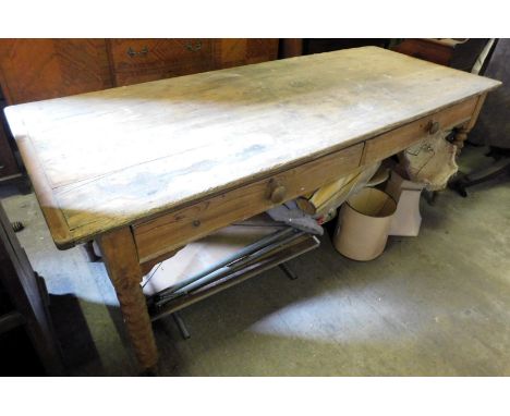 A 19thC pine dairy table, with a planked top above two frieze drawers to one side, on spirally turned legs, 81cm high, 210cm 