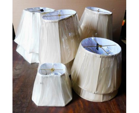 A collection of beige and cream silk lamp shades, various sizes, as new with original shrink wrap. 