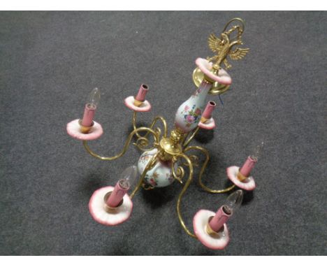A decorative continental ceramic and brass six branch chandelier 