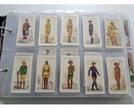 An album containing a large quantity of Wills and John Player cigarette cards, products of the world, cycling, dogs, army lea