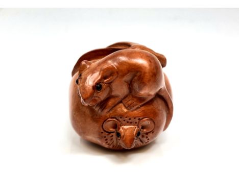 A Japanese carved hardwood netsuke : Rats on Fruit. 
