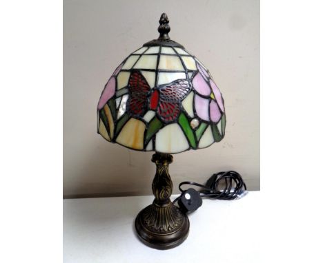 A Tiffany style table lamp with leaded glass butterfly shade 