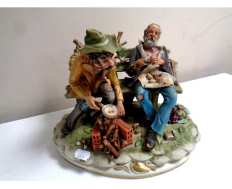 A Capodimonte figure, two vagabonds on a bench by Germano Cortese  