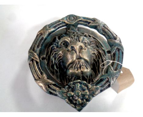 A cast iron lion's head door knocker 