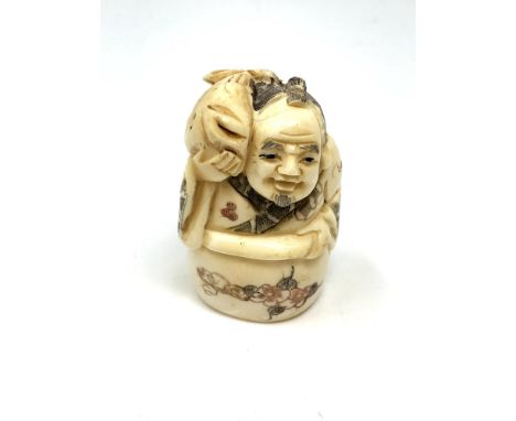 A Japanese carved bone netsuke : Village Elder with Carp. 
