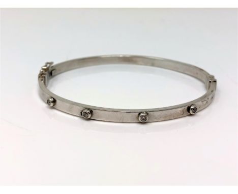 A 9ct white gold diamond set hinged bangle CONDITION REPORT: 5.2g