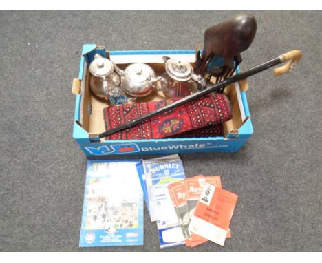 A box containing Persian hearth rug, 1950/60s football programmes, a walking stick parasol, three plated teapots  