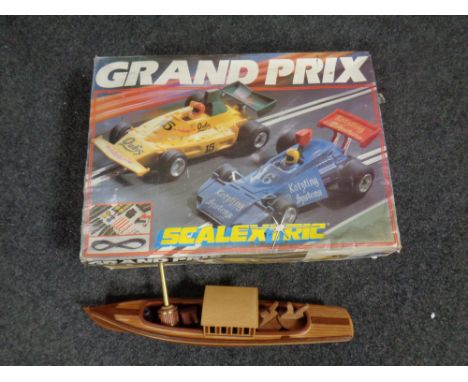 A Scalextric Grand Prix race set in original box together with a wooden model of a pleasure cruiser  