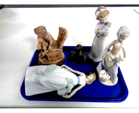 A tray containing three Nao figures together with an Italian pottery figure, seated boy, and a resin figure of otters 