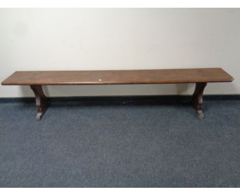 A 20th century pitch pine bench, length 240cm 