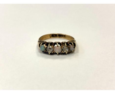 An 18ct gold opal and two stone diamond ring, size I/J, 2.9g.