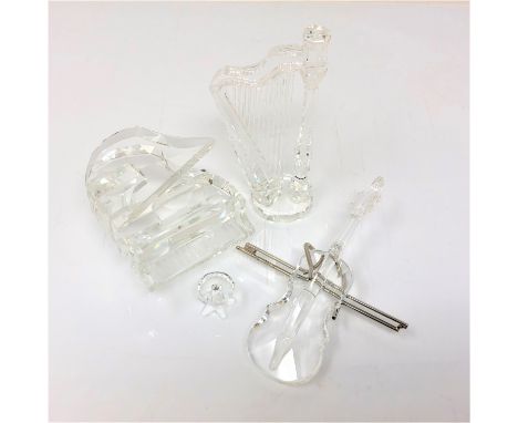 Three Swarovski crystal figures, a grand piano with stool, cello and harp   