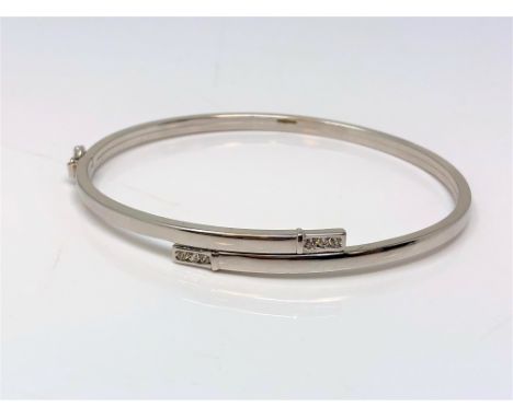 A 9ct white gold diamond set hinged bangle CONDITION REPORT: 4.1g