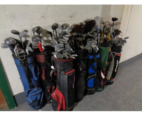 Twelve golf bags containing a large quantity of children's and adult's drivers, irons and putters by Howsen, Challenger, Donn