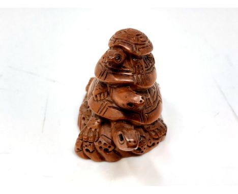 A Japanese carved hardwood netsuke : Three Turtles. 