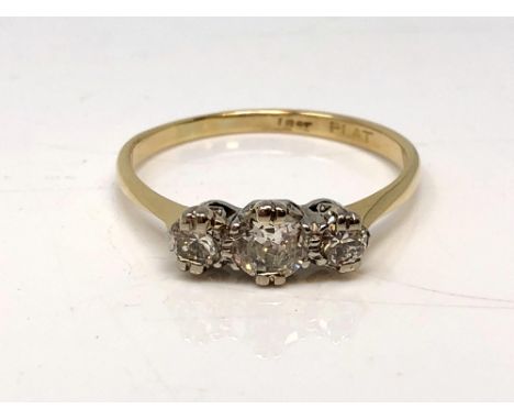 An antique 18ct gold three stone diamond ring, the central stone approx. 0.5 carat, size R. 