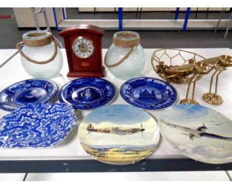 A box of two glass hurricane lamps, pair of brass tea light holders, assorted wall plates, mantel clock etc