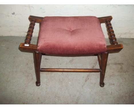 AN ANTIQUE WOODEN PIANO STOOL WITH BOBBIN STYLE LEGS